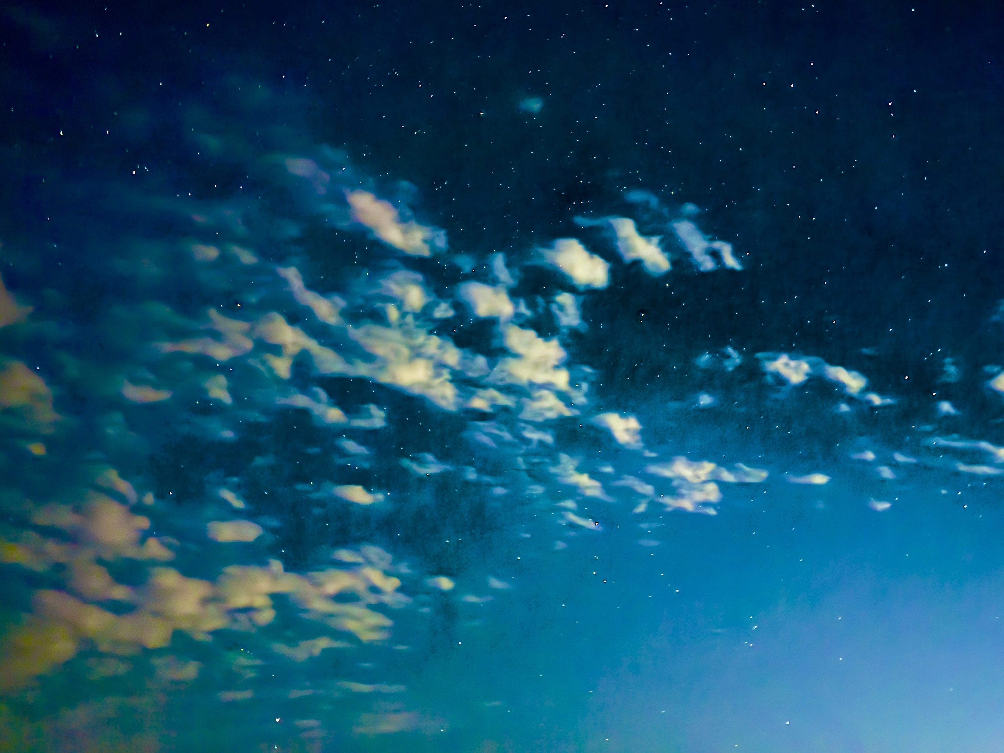 Starry night sky with scattered clouds